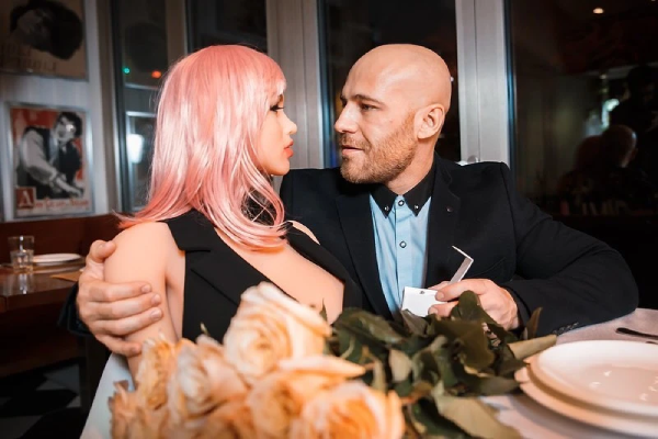 man with his beloved real sex doll.png
